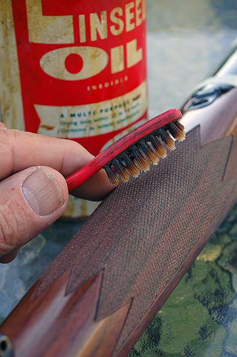 After a refinish, then periodically, toothbrushing in boiled linseed oil cleans and freshens checkering.